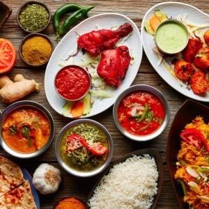 raditional Indian foods including biryani, dosa, butter chicken, naan, and curries served on a dining table.